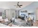 Bright living room features stylish decor, including a ceiling fan, balcony access, and comfortable seating at 8827 Manor Loop # 208, Lakewood Ranch, FL 34202
