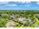 Aerial view of the community pool area surrounded by palm trees and lush landscaping at 8827 Manor Loop # 208, Lakewood Ranch, FL 34202