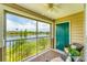 Screened-in lanai featuring outdoor seating with view of a lake and fountain, ideal for relaxation at 8827 Manor Loop # 208, Lakewood Ranch, FL 34202