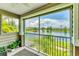 Screened porch view of the lake and fountain surrounded by beautiful, mature landscaping at 8827 Manor Loop # 208, Lakewood Ranch, FL 34202