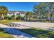 Enjoy a game of volleyball on the community sand court, surrounded by lush landscaping near the townhomes at 8827 Manor Loop # 208, Lakewood Ranch, FL 34202