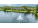 Scenic lake view showcases a fountain, lush greenery, and tropical palm trees at 8827 Manor Loop # 208, Lakewood Ranch, FL 34202