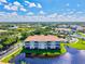 Aerial view of a waterfront condominium complex overlooking a scenic lake with palm trees at 1000 San Lino Cir # 1032, Venice, FL 34292