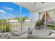 Relaxing screened balcony featuring comfortable seating and views of the lake and lush landscaping at 1000 San Lino Cir # 1032, Venice, FL 34292