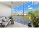Screened balcony with comfortable seating overlooking a serene lake and lush landscaping at 1000 San Lino Cir # 1032, Venice, FL 34292