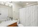 Bathroom with updated vanity, decorative lighting, and white shower curtain at 1000 San Lino Cir # 1032, Venice, FL 34292