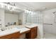 Spacious bathroom with double sinks, glass block, and updated shower at 1000 San Lino Cir # 1032, Venice, FL 34292