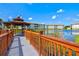 Scenic view of a community gazebo, pathway, and lake with buildings under a sunny, partly cloudy sky at 1000 San Lino Cir # 1032, Venice, FL 34292