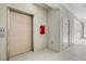 Hallway featuring an elevator and fire extinguisher at 1000 San Lino Cir # 1032, Venice, FL 34292