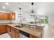 Modern kitchen with stainless steel sink, granite countertops, and wood cabinets at 1000 San Lino Cir # 1032, Venice, FL 34292