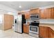 Kitchen with stainless steel appliances and wooden cabinets at 1000 San Lino Cir # 1032, Venice, FL 34292