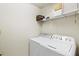 Laundry room shows white washer and dryer with shelving above for storage at 1000 San Lino Cir # 1032, Venice, FL 34292