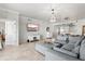 Open-concept living room boasts tile floors, a chandelier, and easy access to the kitchen at 1000 San Lino Cir # 1032, Venice, FL 34292