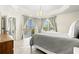 Main bedroom with tray ceiling, chandelier, and access to a balcony through sliding glass doors at 1000 San Lino Cir # 1032, Venice, FL 34292