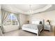 Main bedroom features a tray ceiling, tiled floor, and window with a view at 1000 San Lino Cir # 1032, Venice, FL 34292