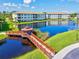 Picturesque gazebo and bridge over a tranquil pond surrounded by lush greenery and community buildings at 1000 San Lino Cir # 1032, Venice, FL 34292