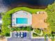Aerial view of community pool area with lounge chairs, lush landscaping, and nearby parking at 1000 San Lino Cir # 1032, Venice, FL 34292