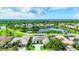 Stunning aerial view of a luxurious home on a pond overlooking a golf course community at 1017 Tuscany Blvd, Venice, FL 34292