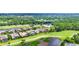 An aerial view showcases the houses in this golf community with ponds and greenery at 1017 Tuscany Blvd, Venice, FL 34292