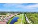 Enjoy picturesque views of a golf course and community with lush landscaping from above at 1017 Tuscany Blvd, Venice, FL 34292