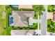 Aerial view of a home with a pool and well-manicured landscaping at 1017 Tuscany Blvd, Venice, FL 34292