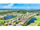 An amazing aerial of an upscale community with lush landscaping, golf course and beautiful ponds at 1017 Tuscany Blvd, Venice, FL 34292