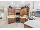 Well-lit kitchen features ample counter space, wood cabinets and stainless steel appliances at 1017 Tuscany Blvd, Venice, FL 34292