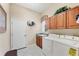 Laundry room with white washer and dryer, sink, and cabinets for storage at 1017 Tuscany Blvd, Venice, FL 34292