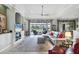 Spacious living room with built-ins, fan, tile flooring and a scenic view to the outside at 1017 Tuscany Blvd, Venice, FL 34292
