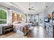 Light and bright main bedroom featuring large windows, tile floors, a ceiling fan, and access to pool at 1017 Tuscany Blvd, Venice, FL 34292