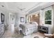 Spacious main bedroom features a large window, tile floors, and seating area at 1017 Tuscany Blvd, Venice, FL 34292