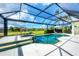 Screened-in pool and spa area featuring golf course views and lush landscaping at 1017 Tuscany Blvd, Venice, FL 34292