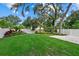 Well-manicured backyard featuring lush green lawn, landscaping and white vinyl privacy fence at 112 17Th E St, Bradenton, FL 34208
