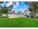 Spacious backyard features a green lawn, white vinyl fence, and a versatile shed at 112 17Th E St, Bradenton, FL 34208