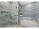 Modern bathroom featuring a glass-enclosed shower, soaking tub, and elegant marble accents at 112 17Th E St, Bradenton, FL 34208