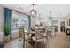 Dining area with stylish lighting and natural light, adjacent to the modern kitchen at 112 17Th E St, Bradenton, FL 34208