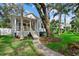 Inviting home with a landscaped front yard, a walkway to a yellow door, and a charming front porch at 112 17Th E St, Bradenton, FL 34208