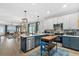 Modern kitchen with stainless steel appliances, stylish lighting, and an island with seating at 112 17Th E St, Bradenton, FL 34208