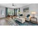 Bright living room features stylish furniture, a plush rug, and decor with an ocean theme at 112 17Th E St, Bradenton, FL 34208
