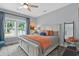 Bright main bedroom with large windows, ceiling fan, and a comfortable, inviting atmosphere at 112 17Th E St, Bradenton, FL 34208