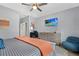 Comfortable main bedroom with mounted TV, ceiling fan, and stylish decor at 112 17Th E St, Bradenton, FL 34208