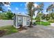 Charming outdoor shed surrounded by manicured lawn and brick paving stones at 112 17Th E St, Bradenton, FL 34208
