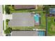 Aerial view of a home's backyard featuring a screened-in pool and well-manicured lawn at 11223 Spring Gate Trl, Bradenton, FL 34211