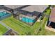 Birds-eye view of fenced backyard, green lawn and pool inside black framed screen enclosure at 11223 Spring Gate Trl, Bradenton, FL 34211