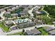 Aerial view of community featuring a pool, playground, and pond with lush greenery at 11223 Spring Gate Trl, Bradenton, FL 34211