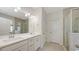 Bright bathroom with double sinks, a walk-in shower, and tiled floors at 11223 Spring Gate Trl, Bradenton, FL 34211