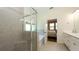 Well-lit primary bathroom with glass-enclosed shower, soaking tub, and double vanity at 11223 Spring Gate Trl, Bradenton, FL 34211