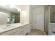 Bright bathroom features double sink vanity with white cabinets and a glass-enclosed shower at 11223 Spring Gate Trl, Bradenton, FL 34211