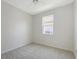 Comfortable bedroom with a ceiling fan, window, and neutral walls at 11223 Spring Gate Trl, Bradenton, FL 34211