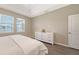Comfortable bedroom with hardwood floors, a ceiling fan, and two large windows at 11223 Spring Gate Trl, Bradenton, FL 34211